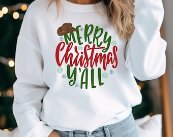 May include: White sweatshirt with a red and green graphic that says "Merry Christmas Y'all" with a brown cowboy hat above the text.