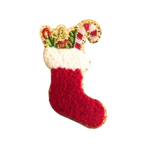 May include: A red and white Christmas stocking with a gold glitter candy cane and green holly.