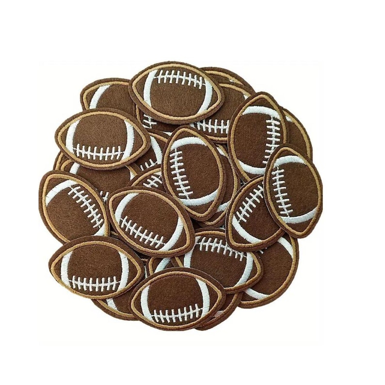 May include: A pile of brown felt football patches with white stitching. The patches are arranged in a circular pattern.