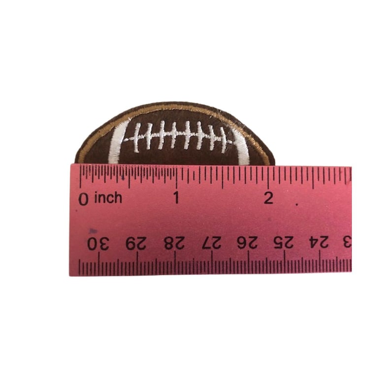 May include: A brown and white embroidered football patch measuring approximately 1 inch in diameter.