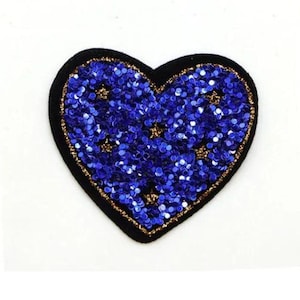 May include: A blue and gold heart-shaped sequin patch. The patch is made of sequins sewn onto a black felt backing.