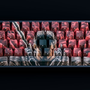 May include: A 60% mechanical keyboard with custom keycaps featuring a dark red and black design. The keycaps have a graphic of a character from a popular anime series. The keyboard has a black frame and a black and white logo on the escape key.