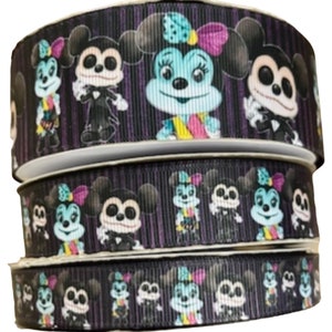 May include: Three spools of black and purple ribbon with a repeating pattern of Mickey Mouse and Minnie Mouse dressed in Halloween costumes.