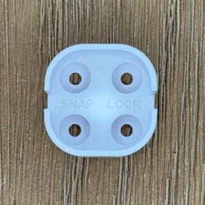 May include: White plastic snap lock with four holes. The text "SNAP LOCK" is printed on the lock.