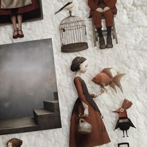 PET tape for journaling and scrapbooking featuring a girl with a goldfish, a boy in a red suit, a bird in a cage, and a suitcase. The figures are in shades of red, brown, and beige, set against a white background.