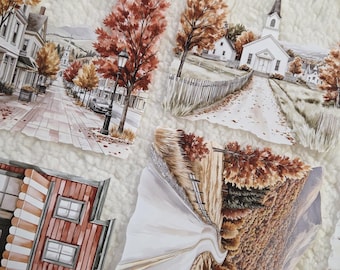 Op de afbeelding: Een verzameling papieren uitsparingen met aquarelillustraties van herfsttaferelen, waaronder een dorpsstraat, een witte kerk met een toren, een rood gebouw met een luifel en een kronkelende weg door een bos met oranje bomen.