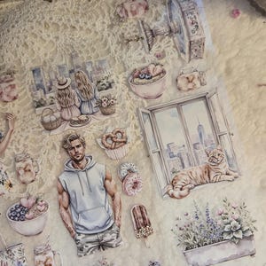 May include: A collection of decorative stickers featuring watercolor illustrations. The stickers depict various scenes, including a picnic, a cat by a window, and food items like donuts and ice cream. The color palette includes soft pastels and detailed artwork.