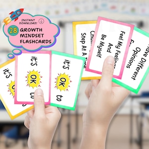 May include: A set of 28 growth mindset flashcards with colorful borders. The cards feature text including 'it's OK to', 'Feel My Feelings And Be Myself', 'Have Different Opinions', and 'Step At A Time'. A pink cloud graphic displays 'INSTANT DOWNLOAD!'