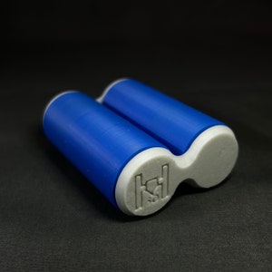 May include: A blue and white plastic roller with a white logo on the side. The logo is a stylized letter "H" with a small circle inside.