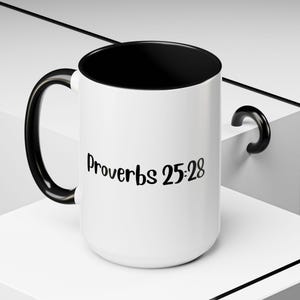 May include: White ceramic mug with a black rim and handle. The mug has the text "Proverbs 25:28" printed in black on the front.