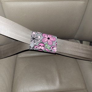 2 Seatbelt adjusters. Changes the angle of the shoulder belt. Simple, sturdy, and affordable solution. These bands have many additional uses