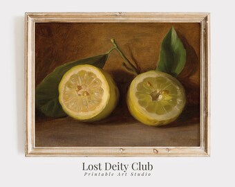 May include: A framed still life painting featuring two halved lemons with green leaves against a brown background. The lemons are yellow with visible seeds. The text "Lost Deity Club Printable Art Studio" is at the bottom.