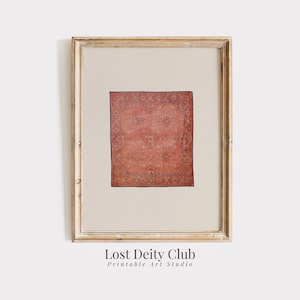 May include: A framed print of a vintage rug with a red, orange, and blue floral pattern. The rug is in a light wood frame.