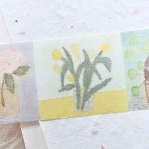 May include: Watercolor illustrations of flowers and plants on a decorative strip. The first square shows a pink hydrangea in a vase. The second square depicts yellow flowers. The third square features a potted plant.