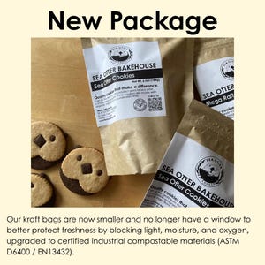 May include: Three brown kraft paper pouches labeled Sea Otter Bakehouse Sea Otter Cookies with a net weight of 6.5oz. Beside the bags are three round cookies featuring a light and dark dough design shaped like a sea otter face with chocolate chips.