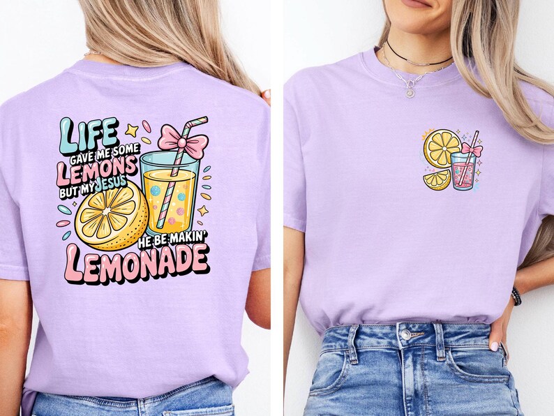 May include: A light purple t-shirt with a graphic design featuring a lemon, a glass of lemonade, and the text "Life gave me some lemons but my Jesus he be makin' lemonade." A smaller version of the design is on the front.