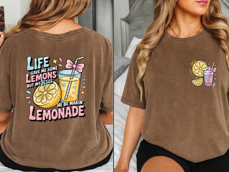 May include: Brown t-shirt with a colorful graphic of a lemon, lemonade, and text that reads "Life gave me some lemons but my Jesus he be makin' lemonade." A smaller version of the graphic is on the front.