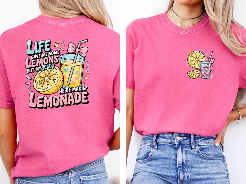 May include: A pink t-shirt with a graphic design featuring a lemon, a glass of lemonade, and the text "Life gave me some lemons but my Jesus he be makin' lemonade."