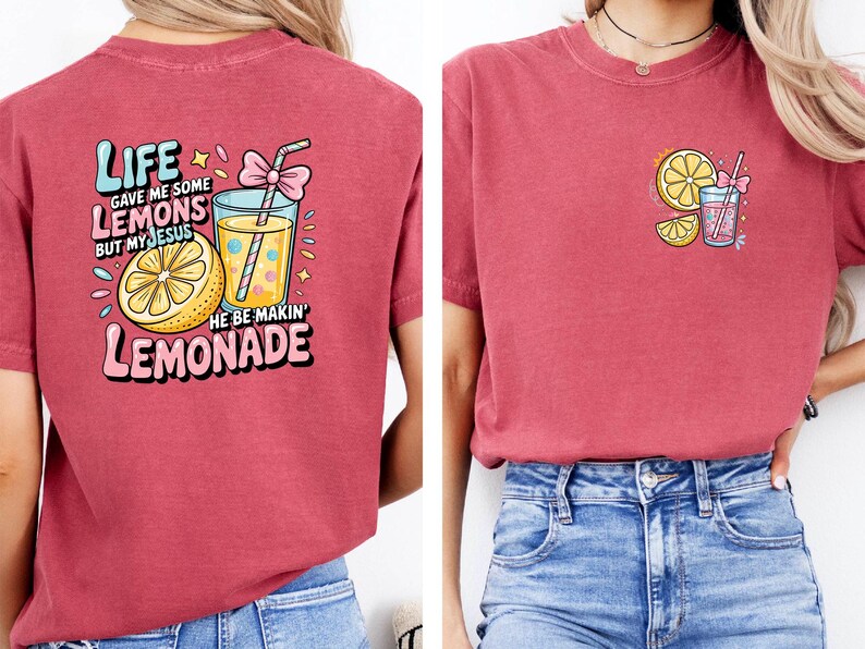 May include: Red t-shirt with a colorful graphic on the front and back. The front graphic features a lemon slice and a drink with a straw. The back graphic says "Life gave me some lemons but my Jesus he be makin' lemonade."