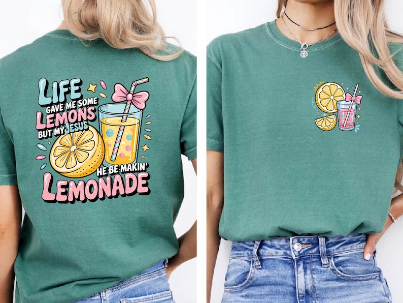 May include: Teal t-shirt with a colorful graphic featuring a lemon, a glass of lemonade, and the text "Life gave me some lemons but my Jesus he be makin' lemonade." The design includes pink and yellow accents.