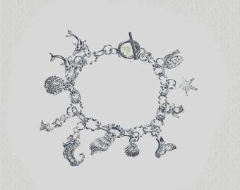 A Seashore Charm Bracelet: Stainless Steel, Silver Alloy Charms