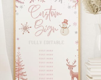 May include: A printable sign with a pink and white winter theme. The sign says "Custom Sign" and has a snowman and a deer. The sign is fully editable and has space for text.