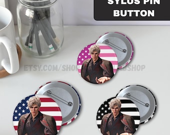 May include: Sylus pin buttons featuring a character illustration with a patriotic theme. The buttons have a metal backing and pin. The background designs include the American flag and star patterns. Text on the image reads "SYLUS PIN BUTTON".