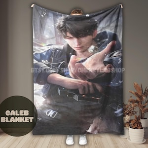 May include: A rectangular throw blanket featuring a digital illustration of a dark-haired character in a blue and black jacket, reaching forward with an open hand. The design includes a metallic belt buckle detail and a soft, blurred background.