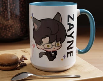 May include: White ceramic mug with a blue rim and handle. The mug features a cartoon illustration of a person with black hair, wearing glasses and a suit, with cat ears. The text "ZAYNE" is printed on the side of the mug.