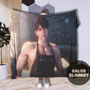 May include: A rectangular fleece blanket featuring a high-resolution print of a young person with dark hair, wearing a black apron over a bare chest. The image displays a soft-focus indoor setting with warm lighting and a subtle, dark color palette.