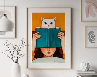 May include: A framed art print featuring a whimsical illustration. A white cat peeks over a teal book held by a person, obscuring their face. The background is orange, with a wooden frame.