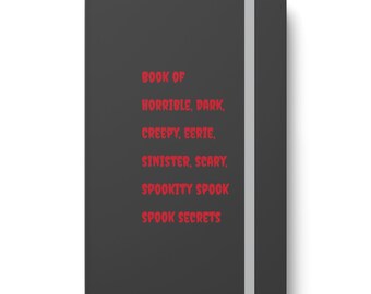 May include: A dark gray journal with a gray ribbon bookmark. The cover has the text "BOOK OF HORRIBLE, DARK, CREEPY, EERIE, SINISTER, SCARY, SPOOKITY SPOOK SPOOK SECRETS" in red.