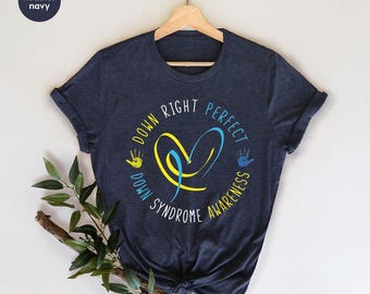 May include: Heather navy blue t-shirt with a yellow and blue heart and the text "Down Right Perfect Down Syndrome Awareness".