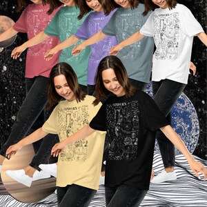May include: A group of seven people wearing t-shirts with a black and white graphic design featuring the zodiac sign Capricorn. The shirts are available in seven different colors: red, green, purple, blue, white, yellow, and black.