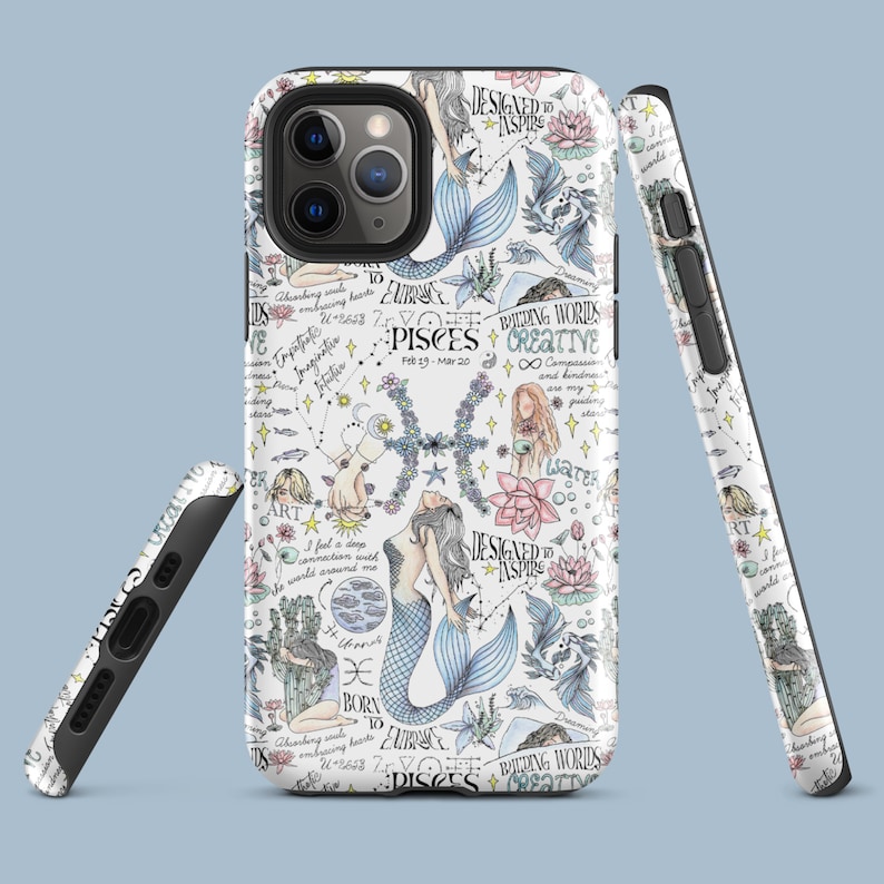 May include: A white phone case with a colorful design featuring a mermaid, flowers, stars, and the zodiac sign Pisces. The text "Designed to Inspire" and "Building Words Creative" are also included.