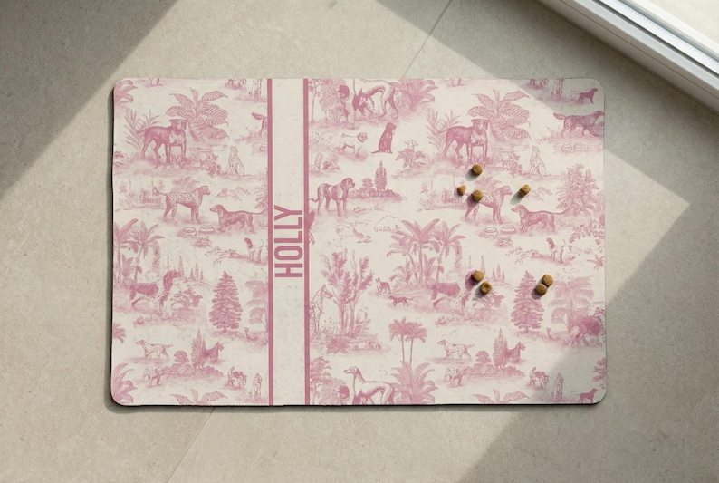 a pink and white patterned mat with various animal illustrations, including horses, dogs, and palm trees, arranged on a light-colored surface.