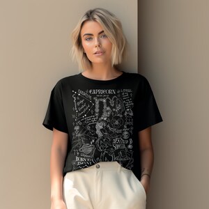 May include: Black t-shirt with a white graphic design featuring the zodiac sign Capricorn and the text "Creative Capricorn Loyal" and "Born to Ascend".