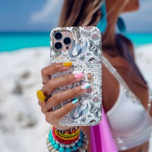 May include: A white phone case with a mermaid design and the words "Pisces", "Designed to Inspire", "Building Worlds", and "Creative".
