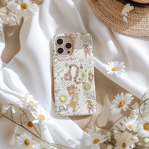 May include: A white phone case with a colorful design featuring a zodiac sign, flowers, and the text "Designed to Inspire" and "Born to Glow".