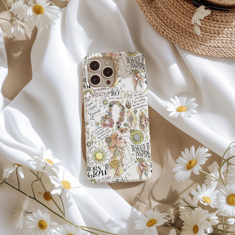 May include: A white phone case with a colorful design featuring a zodiac sign, flowers, and the text "Designed to Inspire" and "Born to Glow".