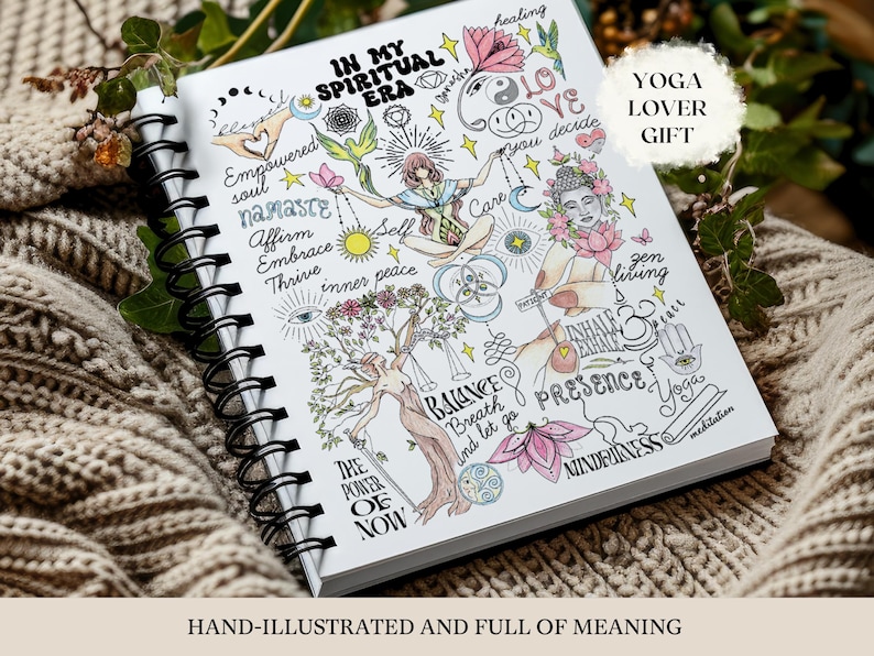 Peut inclure: Un carnet &agrave; spirales avec une couverture blanche orn&eacute;e d'illustrations color&eacute;es de personnages, de fleurs de lotus et de symboles c&eacute;lestes. Le texte indique IN MY SPIRITUAL ERA, Empowered soul, namaste, Affirm, Embrace, Thrive, inner peace, Balance, Breath, and let go, THE POWER OF NOW, Care, zen living, INHALE EXHALE, PRESENCE, MINDFULNESS et meditation.