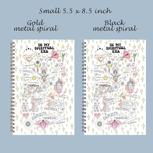 Peut inclure: Deux carnets &agrave; spirales de 14 x 21,6 cm avec une couverture blanche orn&eacute;e d'&eacute;toiles jaunes, d'une personne en m&eacute;ditation, de fleurs de lotus et du texte IN MY SPIRITUAL ERA. L'un a une spirale en m&eacute;tal dor&eacute;, l'autre en m&eacute;tal noir.