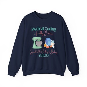 May include: Navy blue sweatshirt with a graphic of a stand mixer and baking ingredients. The text reads "Medical Coding Hobby Edition" and "Injured while cooking or baking Y93.G3".
