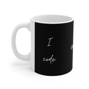 May include: White ceramic mug with a black panel displaying the text "I code, therefore I am" in white script. The mug has a curved handle and a glossy finish, suitable for hot drinks.