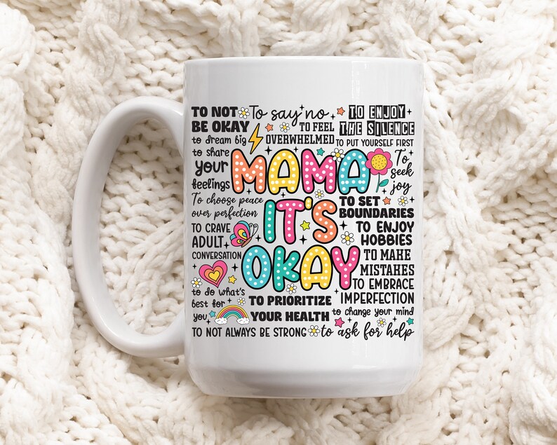 May include: White ceramic mug with a colorful design that says "Mama it's okay" and includes a list of affirmations for self-care, such as "to not say no", "to enjoy the silence", "to set boundaries", "to prioritize your health", and "to ask for help".