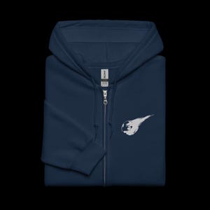 May include: A navy blue zippered hoodie with a white graphic of a meteor and a hand.