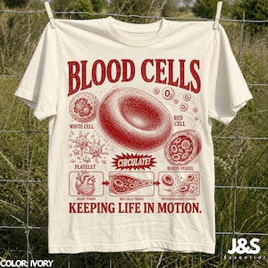 May include: An ivory short-sleeve t-shirt featuring a red graphic print of blood cells, platelets, and a heart. The text reads BLOOD CELLS, CIRCULATE!, and KEEPING LIFE IN MOTION, along with labels for red cell, white cell, and blood vessel components.