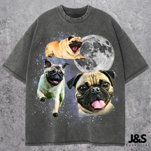 May include: Dark grey t-shirt with three pug illustrations, a full moon, and a starry background. The pugs are in different poses, including one running and another with its tongue out. The text "J&S Essential" is at the bottom of the shirt.