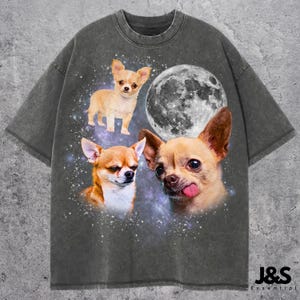 May include: Dark gray t-shirt featuring a graphic design of three Chihuahuas, a full moon, and a starry background. The shirt has a distressed, vintage look. The brand name "J&S Essential" is printed in white at the bottom right.