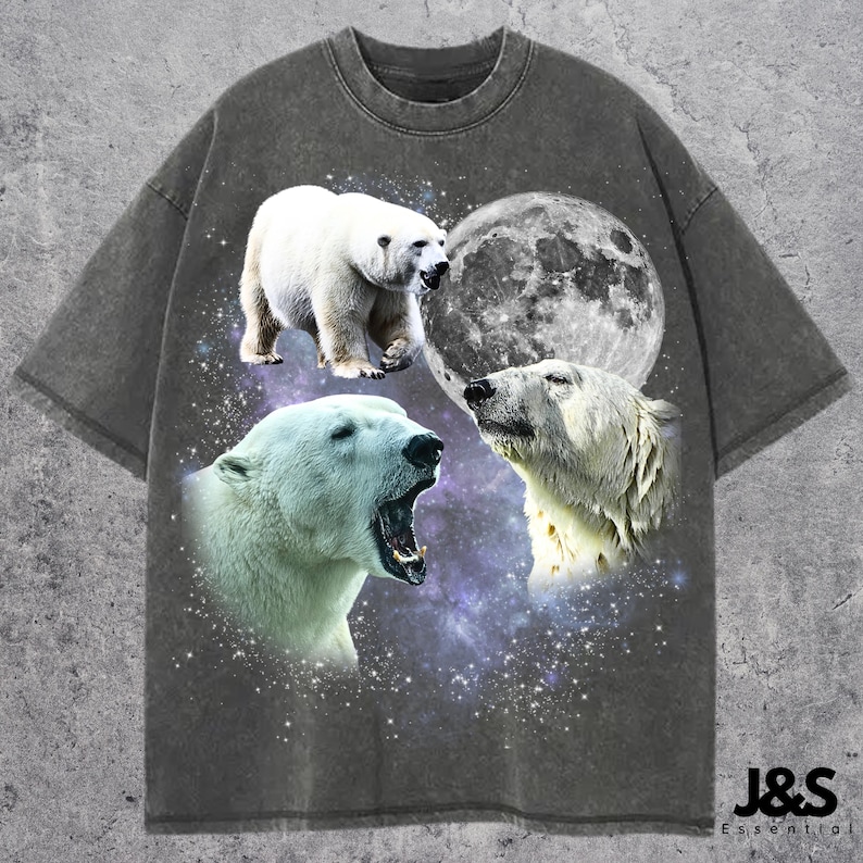 May include: Dark gray t-shirt featuring a graphic of three polar bears, a full moon, and a starry background. The shirt has a vintage, washed look. The text "J&S Essential" is at the bottom right.